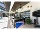 Screened patio with outdoor seating, TV, ceiling fans, and views of the pool and canal at 1255 Eider Ct, Punta Gorda, FL 33950