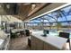 Outdoor kitchen and seating area overlooking pool and canal, perfect for entertaining or relaxing at 1255 Eider Ct, Punta Gorda, FL 33950