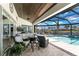 Screened in porch with outdoor seating, ceiling fans, views of the pool, spa, and waterfront at 1255 Eider Ct, Punta Gorda, FL 33950
