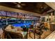 Covered lanai with a fire pit and seating area overlooking the pool at 1255 Eider Ct, Punta Gorda, FL 33950