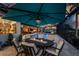 Outdoor dining area with a large umbrella and pool view at 1255 Eider Ct, Punta Gorda, FL 33950