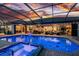 Outdoor oasis featuring a screened-in pool, spa, and outdoor kitchen with bar seating at 1255 Eider Ct, Punta Gorda, FL 33950