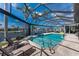 Relaxing screened-in pool area with a spa, comfortable lounge chairs, and views of the canal at 1255 Eider Ct, Punta Gorda, FL 33950