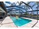 Bright, screened-in pool area with a spa and canal views, perfect for outdoor entertaining at 1255 Eider Ct, Punta Gorda, FL 33950
