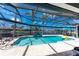 Beautiful screened-in pool with a hot tub and outdoor dining area, overlooking the canal at 1255 Eider Ct, Punta Gorda, FL 33950