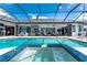 Beautiful pool and spa with clear water, blue tile, and outdoor living area at 1255 Eider Ct, Punta Gorda, FL 33950
