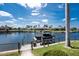 Scenic view of the waterfront property with a boat dock and lush landscaping at 1255 Eider Ct, Punta Gorda, FL 33950