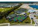 Aerial view of community featuring tennis, pickleball courts, clubhouse, pool and lake at 14051 Heritage Landing Blvd # 536, Punta Gorda, FL 33955