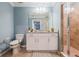 Bright bathroom featuring a single vanity with a granite countertop and a glass-enclosed shower at 14051 Heritage Landing Blvd # 536, Punta Gorda, FL 33955