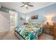 Cozy bedroom with a ceiling fan, neutral carpet, and a tropical-themed comforter on the bed at 14051 Heritage Landing Blvd # 536, Punta Gorda, FL 33955