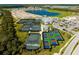 An aerial photograph showcases tennis and pickleball courts at this community, a lake, and other amenities at 14051 Heritage Landing Blvd # 536, Punta Gorda, FL 33955