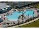 Bird's eye view of a uniquely shaped community pool with a spa and plenty of seating for residents at 14051 Heritage Landing Blvd # 536, Punta Gorda, FL 33955