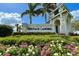 Community entrance sign with beautiful landscaping, flowers and clear blue sky at 14051 Heritage Landing Blvd # 536, Punta Gorda, FL 33955