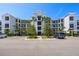 Low-rise condo building with beautiful landscaping, mature palms, and plenty of parking spaces at 14051 Heritage Landing Blvd # 536, Punta Gorda, FL 33955