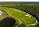 Scenic aerial view of the golf course, with pristine greens, lakes, and lush trees showcasing the community's beauty at 14051 Heritage Landing Blvd # 536, Punta Gorda, FL 33955