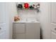 Efficient laundry area features a stacked washer and dryer and convenient shelving at 14051 Heritage Landing Blvd # 536, Punta Gorda, FL 33955