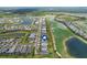 Panoramic aerial view showcases a community nestled among lakes, golf courses, and lush greenery at 15830 Appalachian Dr, Punta Gorda, FL 33982