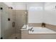 Bright bathroom boasts a soaking tub and a glass-enclosed shower at 15830 Appalachian Dr, Punta Gorda, FL 33982