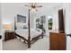 Charming bedroom with a four-poster bed, soft white linens, and bright windows offering views of the lush outdoors at 15830 Appalachian Dr, Punta Gorda, FL 33982