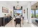 Bright dining room is illuminated by a modern chandelier and filled with natural light at 15830 Appalachian Dr, Punta Gorda, FL 33982