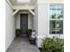 Inviting home exterior features a front door with a decorative seating area, manicured bushes and plenty of natural light at 15830 Appalachian Dr, Punta Gorda, FL 33982