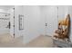 Bright hallway featuring neutral walls, a decorative table, and access to the bathroom, door to living areas, and bedrooms at 15830 Appalachian Dr, Punta Gorda, FL 33982