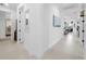 Bright, neutral hallway showcases the home's open floor plan and elegant tile flooring at 15830 Appalachian Dr, Punta Gorda, FL 33982