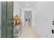A bright and airy hallway with neutral-toned walls and floors leads to the main living areas of this lovely home at 15830 Appalachian Dr, Punta Gorda, FL 33982