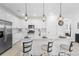 Bright, modern kitchen with white cabinetry, a large island, and stainless steel appliances at 15830 Appalachian Dr, Punta Gorda, FL 33982