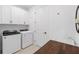 Bright laundry room equipped with modern appliances, ample storage cabinets, a utility sink and a butcher block countertop at 15830 Appalachian Dr, Punta Gorda, FL 33982