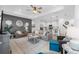 Open-concept living room with a gray accent wall, neutral furnishings, and seamless flow to the kitchen at 15830 Appalachian Dr, Punta Gorda, FL 33982