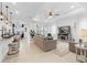 Bright and airy living room with a tray ceiling, tile floors, and open access to other rooms at 15830 Appalachian Dr, Punta Gorda, FL 33982