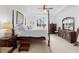 The main bedroom features a four-poster bed, carpet flooring, and a ceiling fan at 15830 Appalachian Dr, Punta Gorda, FL 33982