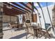 Well-equipped outdoor kitchen with a grill, sink, and dining area under a pergola at 15830 Appalachian Dr, Punta Gorda, FL 33982