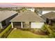 Aerial view of the home's rear exterior featuring a screened-in lanai and manicured backyard at 15830 Appalachian Dr, Punta Gorda, FL 33982