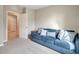 Bedroom features a comfortable blue couch, a neutral color palette, and an open doorway at 16031 Quinta Dr, Punta Gorda, FL 33955