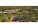 Expansive aerial view of a charming home surrounded by lush greenery and a serene waterway at 17356 Gulfspray Cir, Port Charlotte, FL 33948