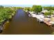 Aerial shot of waterfront property featuring lush surroundings and boat docks at 17356 Gulfspray Cir, Port Charlotte, FL 33948