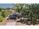 Aerial view showcasing the home's roof, yard, and proximity to mature trees for added privacy at 17356 Gulfspray Cir, Port Charlotte, FL 33948