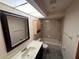 Bright bathroom with a vanity, toilet, shower, and a skylight overhead at 17356 Gulfspray Cir, Port Charlotte, FL 33948