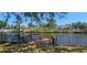 Private wooden dock on the water, perfect for relaxing or fishing in the backyard at 17356 Gulfspray Cir, Port Charlotte, FL 33948