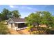 Aerial of charming house with a screened porch, mature trees, and private water access at 17356 Gulfspray Cir, Port Charlotte, FL 33948