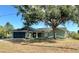 Charming single-story home with well-maintained lawn, two-car garage, and mature trees at 17356 Gulfspray Cir, Port Charlotte, FL 33948