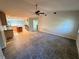 Spacious living room with tile flooring, ceiling fan, and open floor plan to the kitchen at 17356 Gulfspray Cir, Port Charlotte, FL 33948