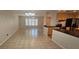 Bright, open living and dining area with tile floors, ceiling fan and direct access to the modern kitchen at 17356 Gulfspray Cir, Port Charlotte, FL 33948