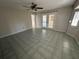 Bright living room with tile flooring, ceiling fan, and double doors leading outside at 17356 Gulfspray Cir, Port Charlotte, FL 33948