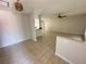 Spacious living room with neutral walls, tile flooring, and a ceiling fan for comfortable living at 17356 Gulfspray Cir, Port Charlotte, FL 33948