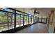 Relaxing sunroom featuring tile floors, ceiling fan, and scenic views of the surrounding landscape and waterway at 17356 Gulfspray Cir, Port Charlotte, FL 33948