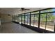 Bright sunroom with tiled floors and expansive windows showcasing serene water views at 17356 Gulfspray Cir, Port Charlotte, FL 33948