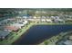 Stunning aerial view of a residential community with beautiful houses surrounding a pond at 1745 Hyssop Loop, North Port, FL 34289